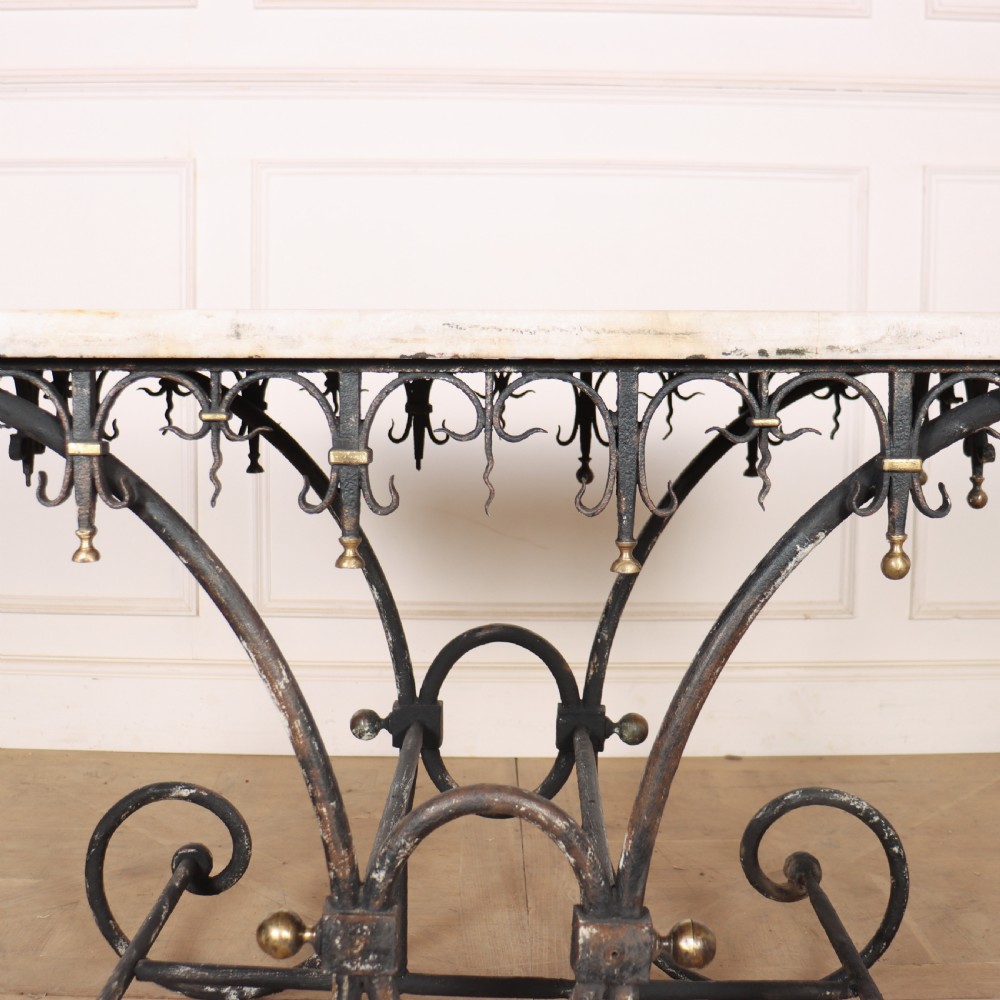 A 19th-century French patisserie table featuring a light marble top mounted on a dark wrought iron scrolled base with brass details. View VII