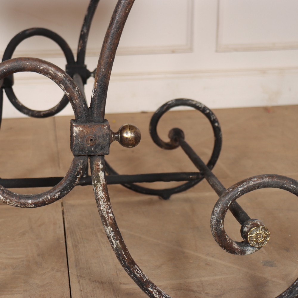 A 19th-century French patisserie table featuring a light marble top mounted on a dark wrought iron scrolled base with brass details. View VIII