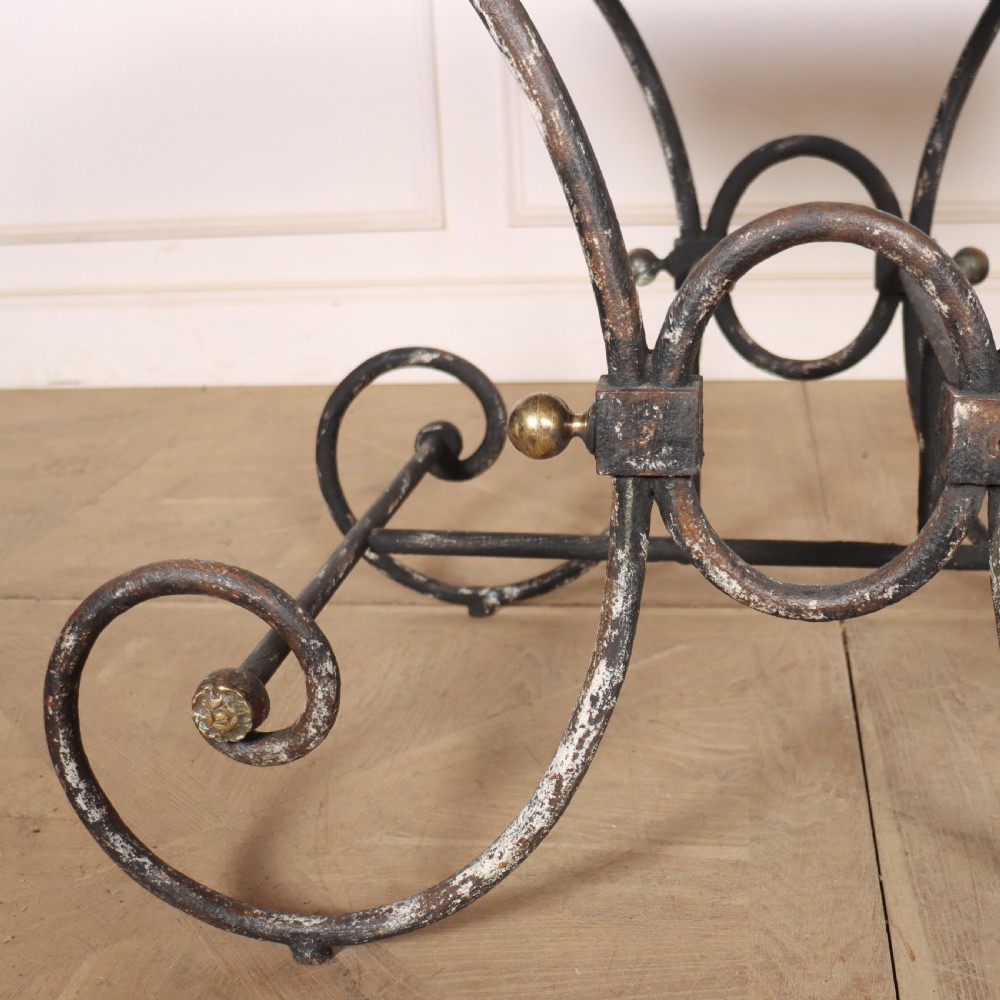 A 19th-century French patisserie table featuring a light marble top mounted on a dark wrought iron scrolled base with brass details. View IX