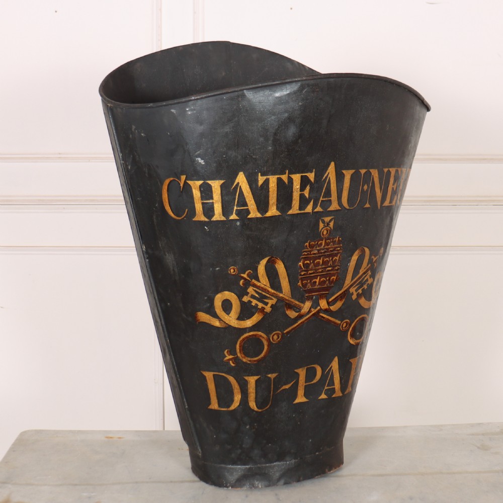 A tapered black painted sheet metal grape picking hotte with gold hand-painted lettering reading Chateauneuf du-Pape and a crest motif. View II