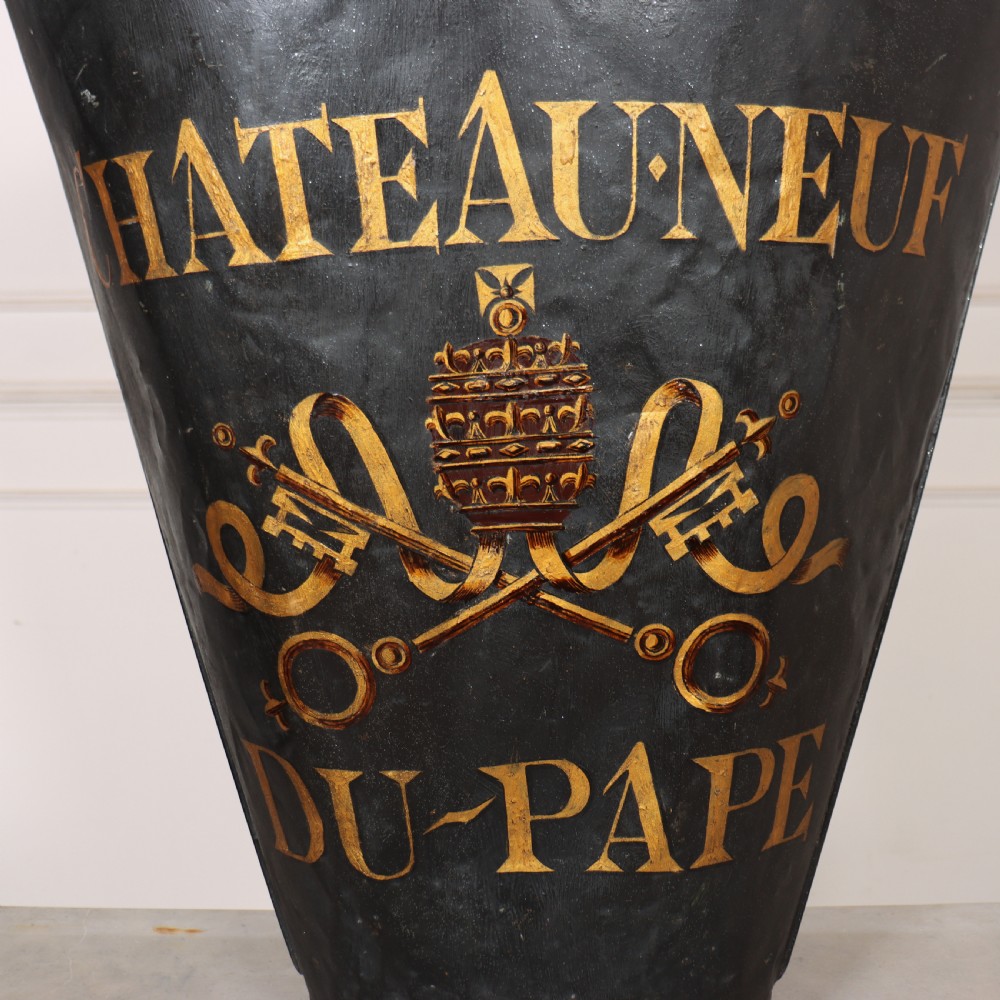 A tapered black painted sheet metal grape picking hotte with gold hand-painted lettering reading Chateauneuf du-Pape and a crest motif. View III