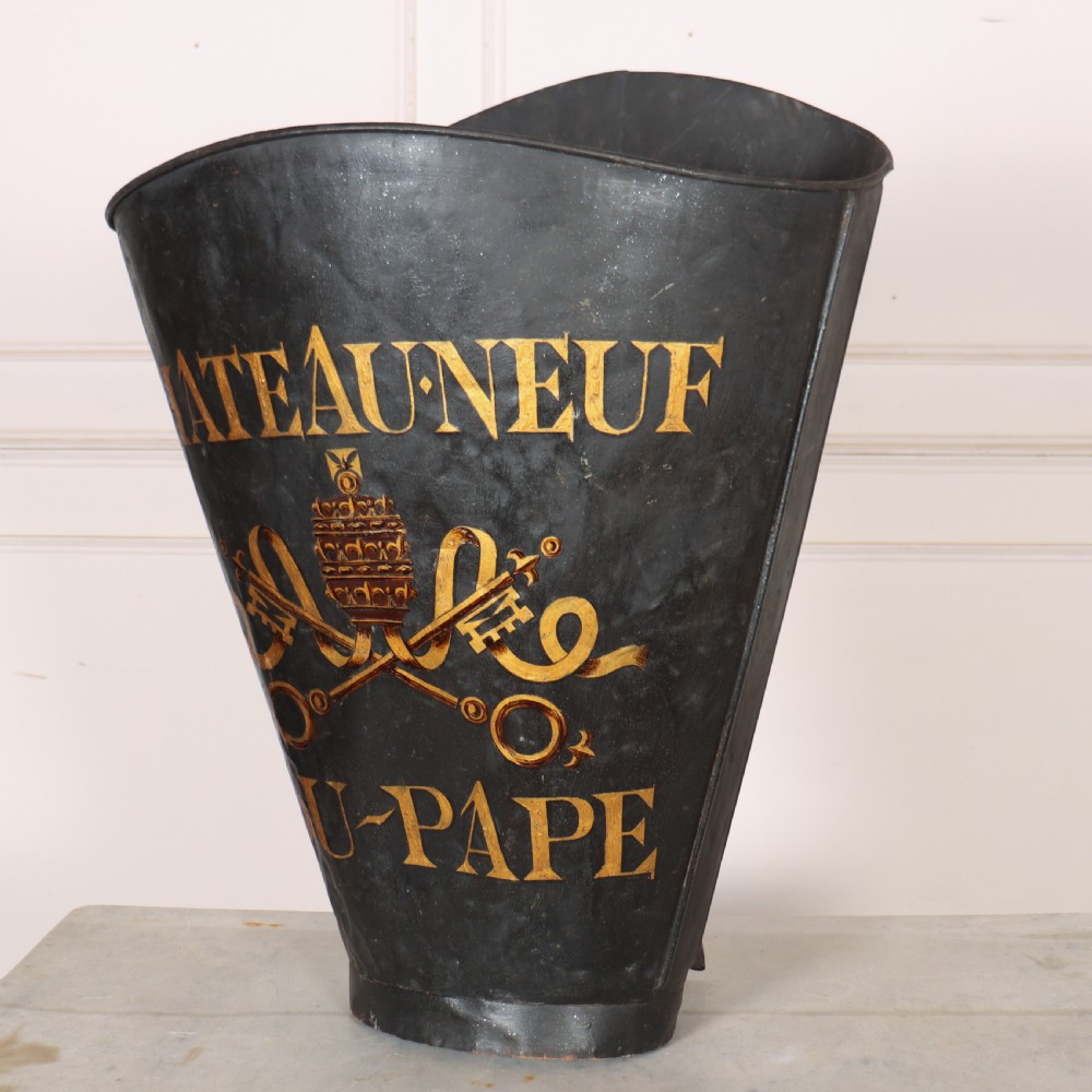 A tapered black painted sheet metal grape picking hotte with gold hand-painted lettering reading Chateauneuf du-Pape and a crest motif. View IV