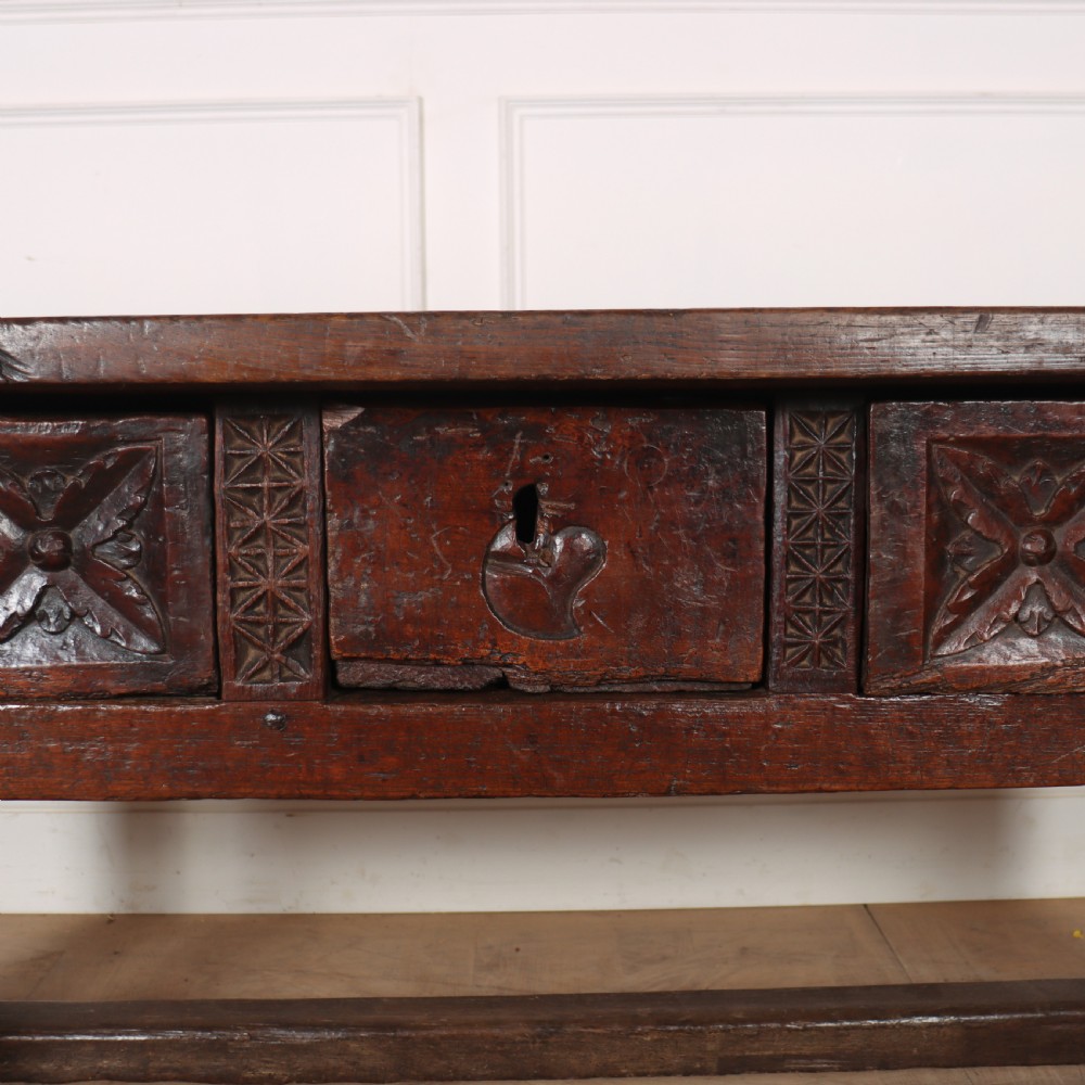 A 17th-century Spanish dark oak console table featuring a thick rectangular top over three geometric carved drawers, supported by sturdy legs with a perimeter stretcher. View III