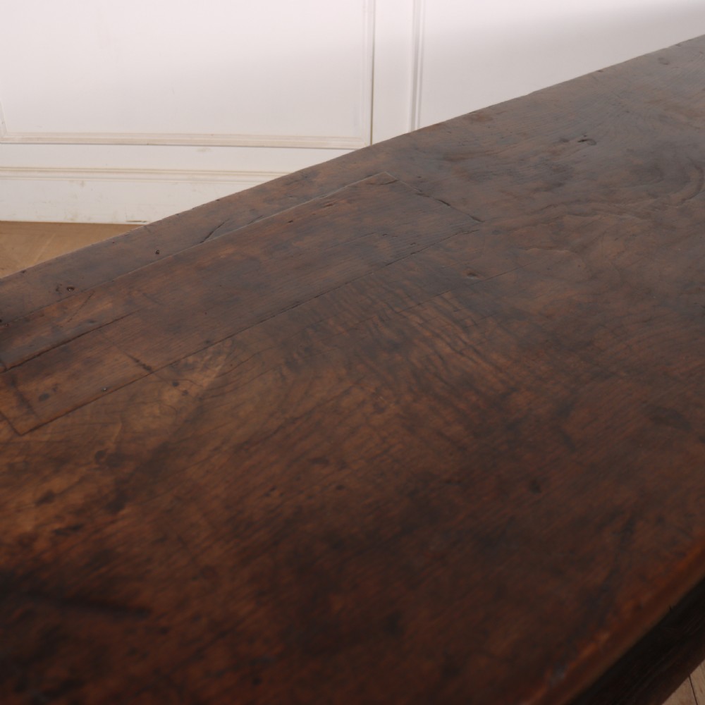 A 17th-century Spanish dark oak console table featuring a thick rectangular top over three geometric carved drawers, supported by sturdy legs with a perimeter stretcher. View X