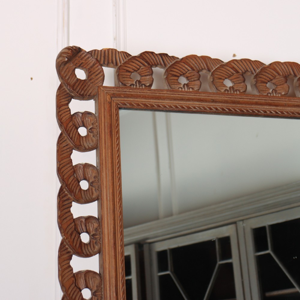 A rectangular wall mirror featuring an intricate hand-carved pine frame with an openwork twist pattern and warm wood finish. View II