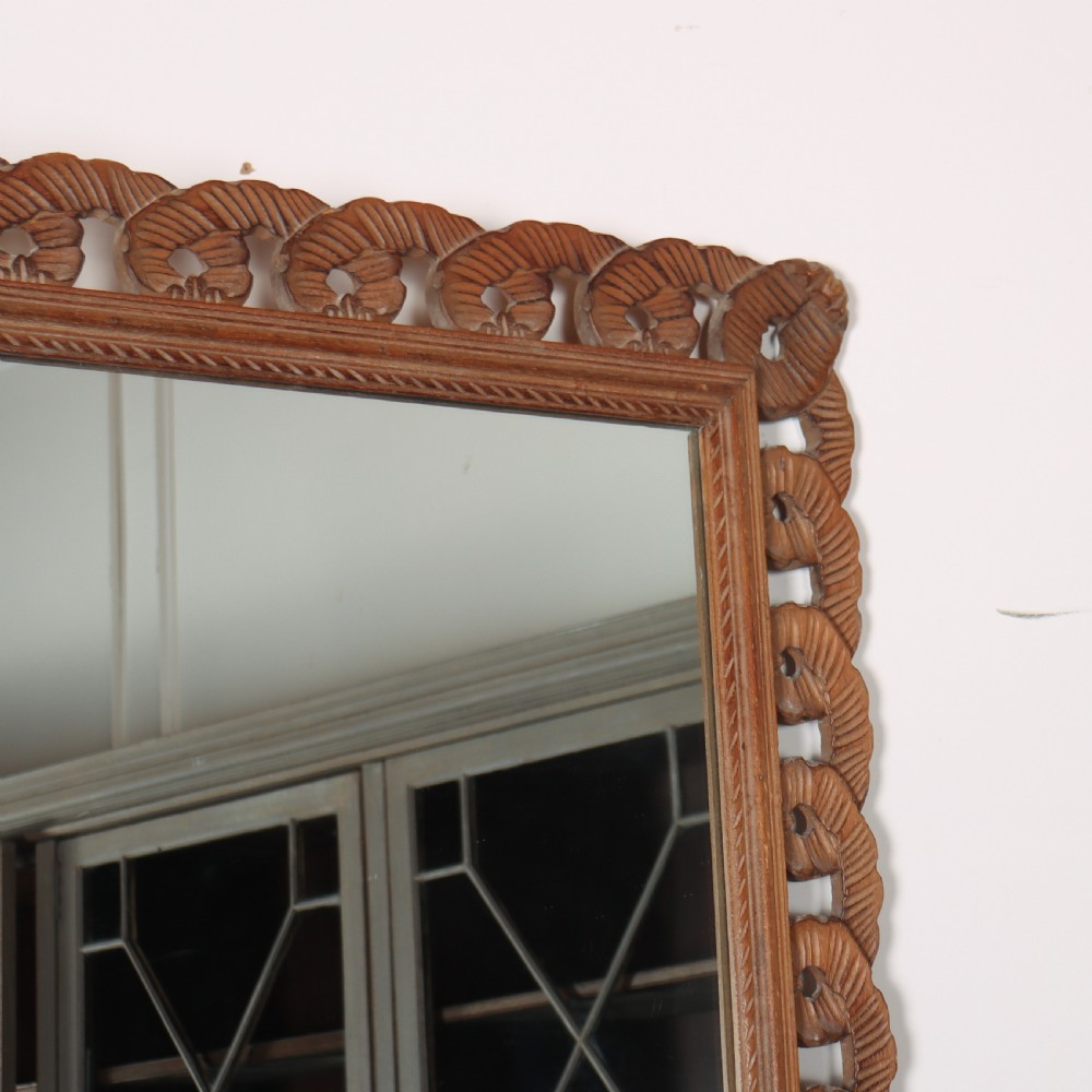 A rectangular wall mirror featuring an intricate hand-carved pine frame with an openwork twist pattern and warm wood finish. View III