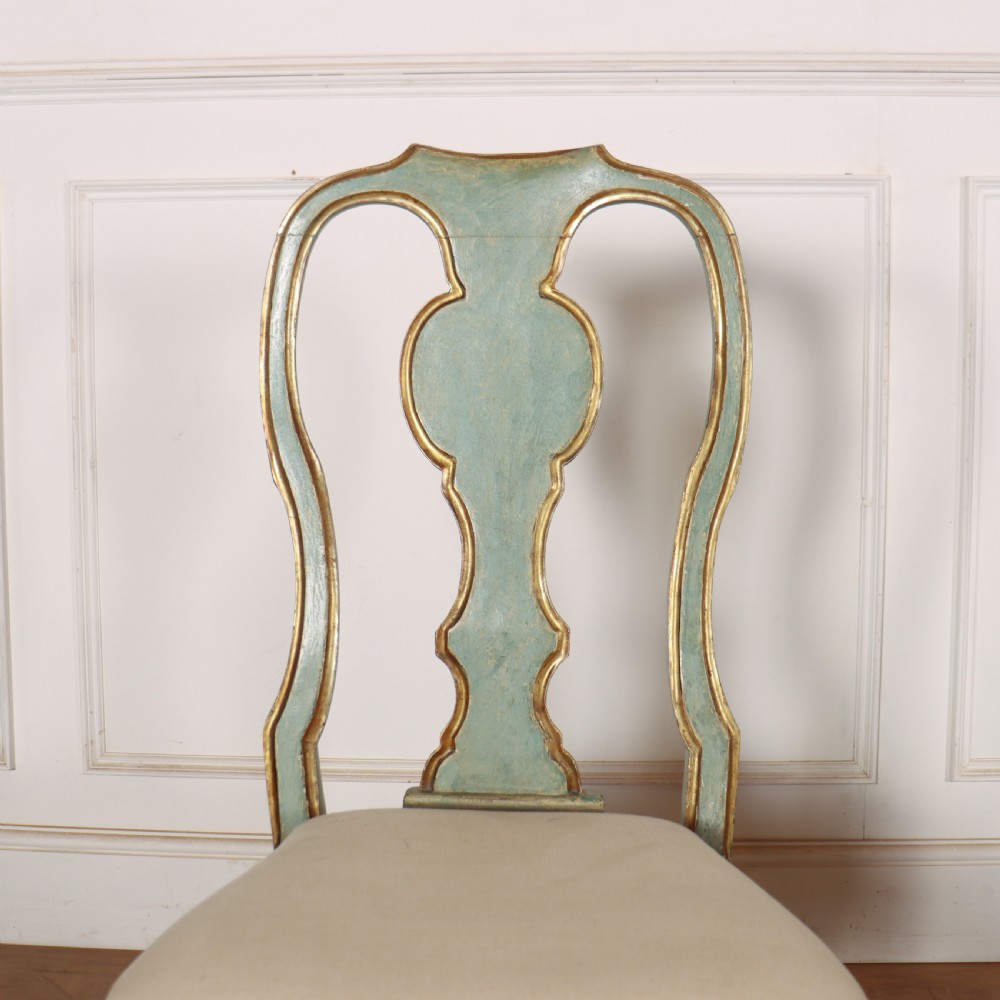 A set of twelve 18th-century Italian Rococo side chairs with pale green painted frames, parcel-gilt detailing, and cream upholstered seats. View VIII