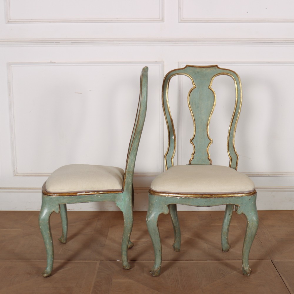 A set of twelve 18th-century Italian Rococo side chairs with pale green painted frames, parcel-gilt detailing, and cream upholstered seats. View XI