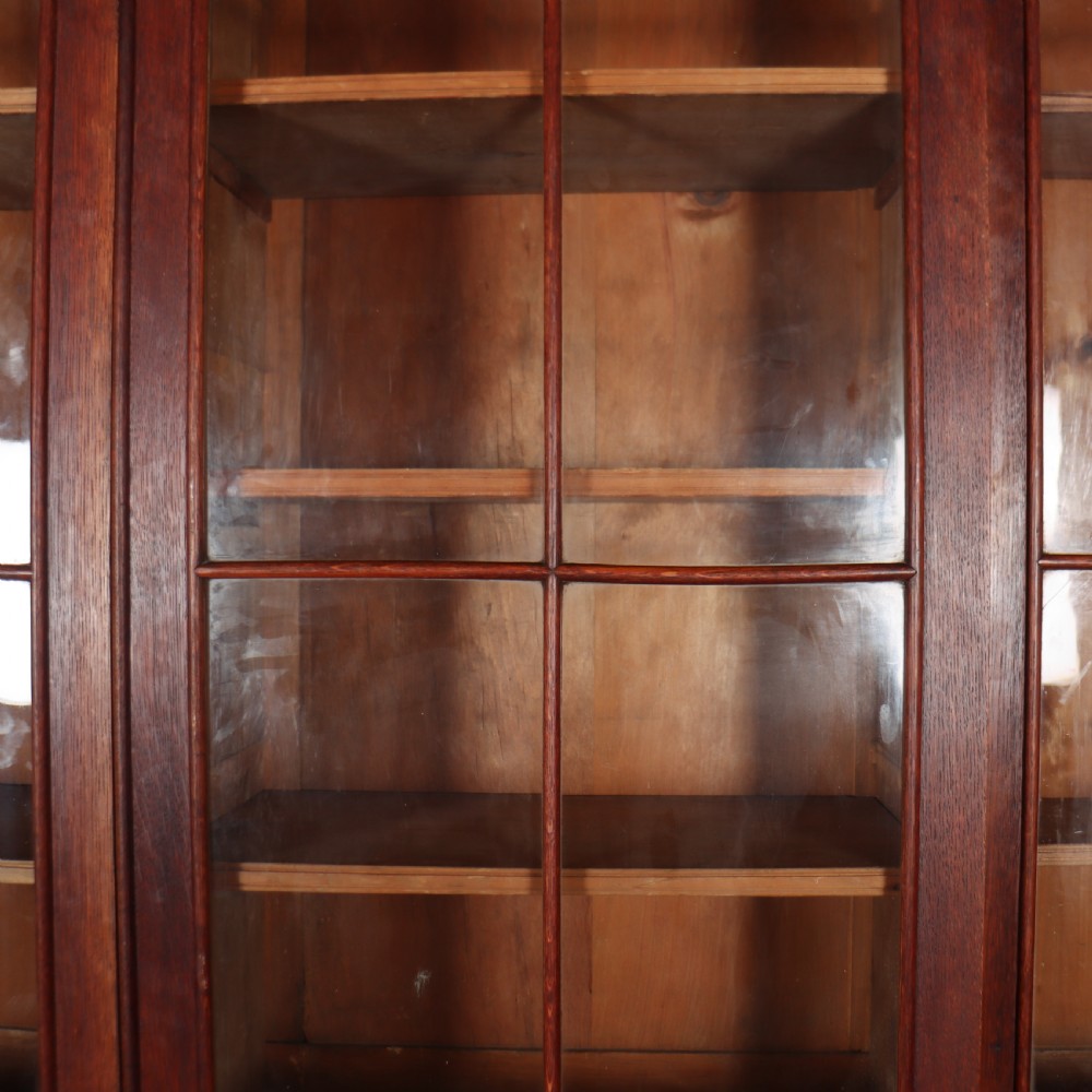 An early 19th-century mahogany breakfront bookcase featuring four glazed doors with Gothic pointed arch tracery over four matching panelled base doors. View VIII
