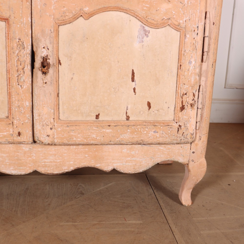 An 18th-century French provincial buffet featuring a distressed beige painted finish, two drawers, two carved panel cupboard doors, and short cabriole legs. View IV