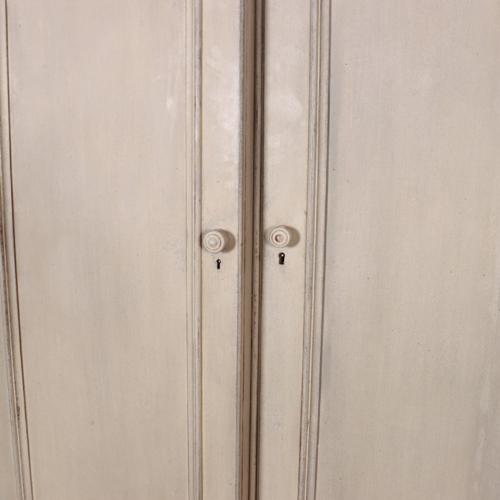 A large 19th-century painted wooden three-door wardrobe featuring carved Gothic arches and a detailed crown moulding cornice. View VI