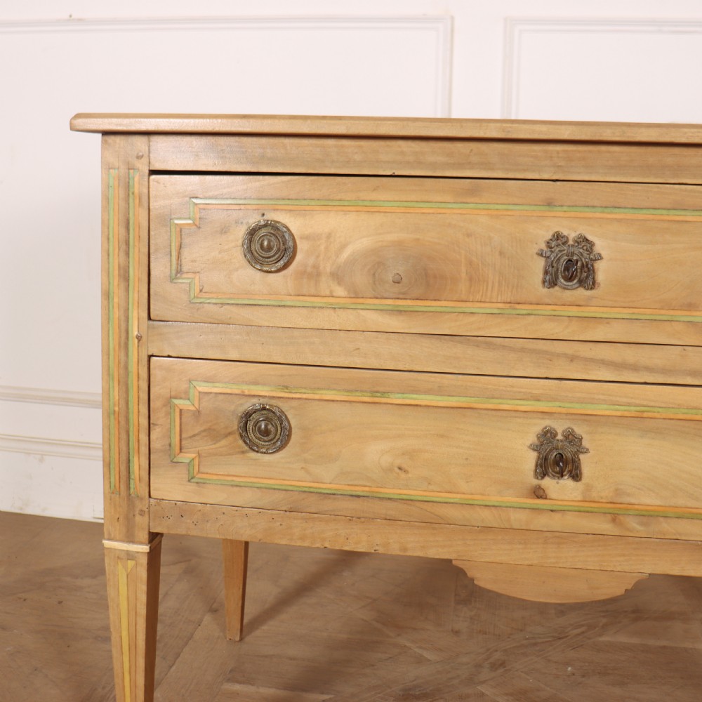 A 19th-century bleached walnut Italian commode featuring two wide drawers with painted border details, circular brass handles, and square tapered legs. View II