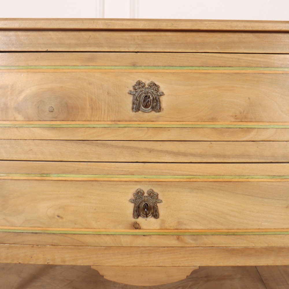 A 19th-century bleached walnut Italian commode featuring two wide drawers with painted border details, circular brass handles, and square tapered legs. View V