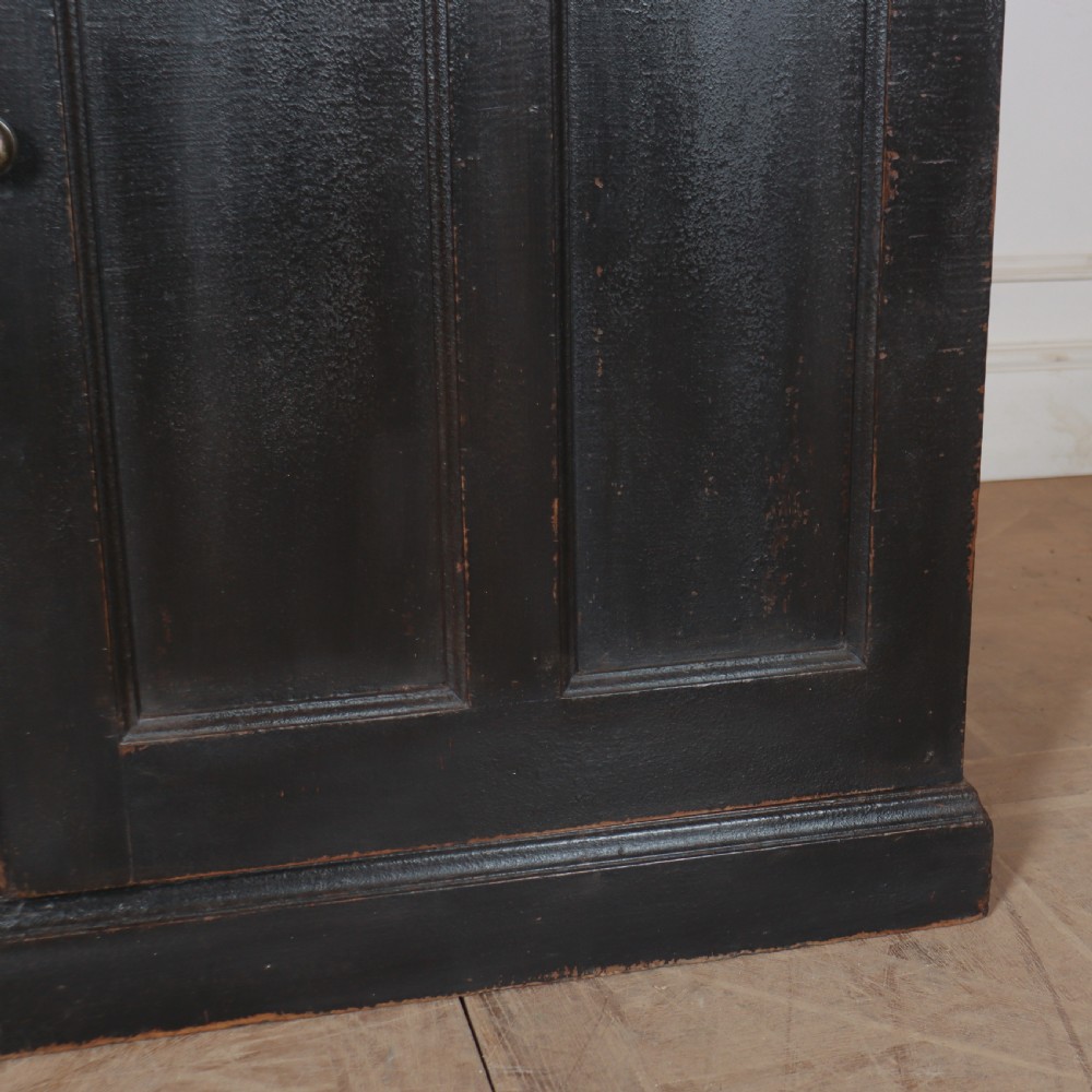 A 19th-century English painted open bookcase featuring a dark exterior, contrasting off-white interior shelves, and a lower two-door cupboard. View VIII