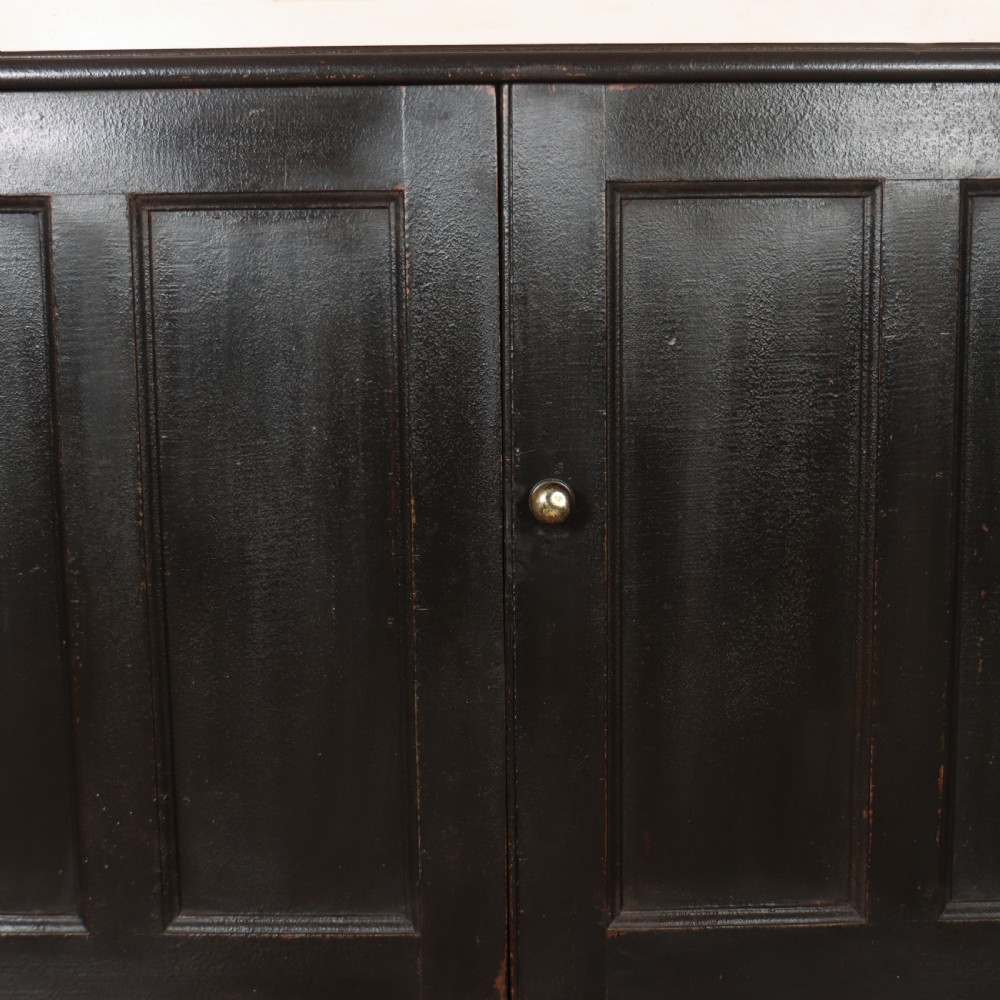 A 19th-century English painted open bookcase featuring a dark exterior, contrasting off-white interior shelves, and a lower two-door cupboard. View IX
