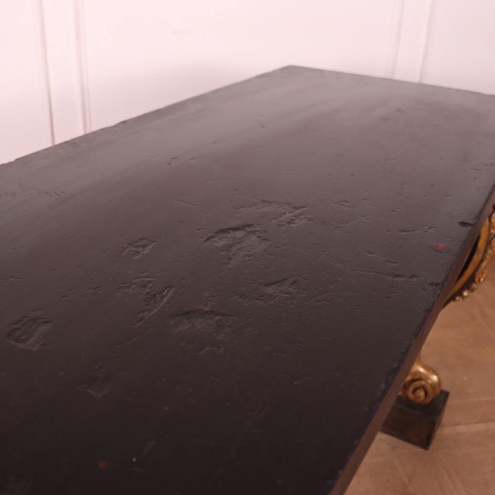 A dark painted and parcel-gilt console table featuring carved acanthus leaf scroll front supports and a flat plinth base. View X