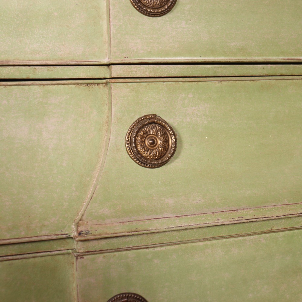 A large sage green painted Dutch linen cupboard featuring a broken pediment cornice, carved swag door panels, brass drop handles, and three lower drawers. View XIV