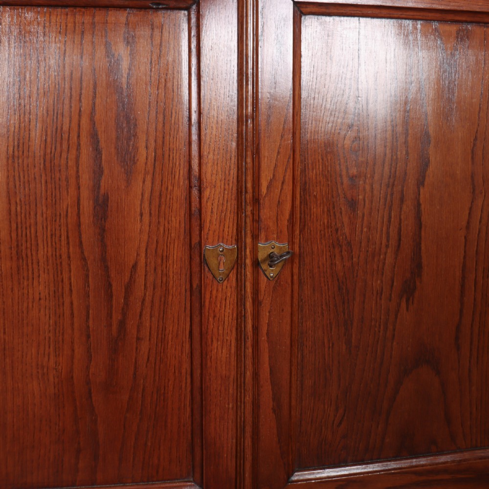 A long French oak enfilade sideboard featuring four field-panel cupboard doors, upper drawers, and central brass key escutcheons. View VI