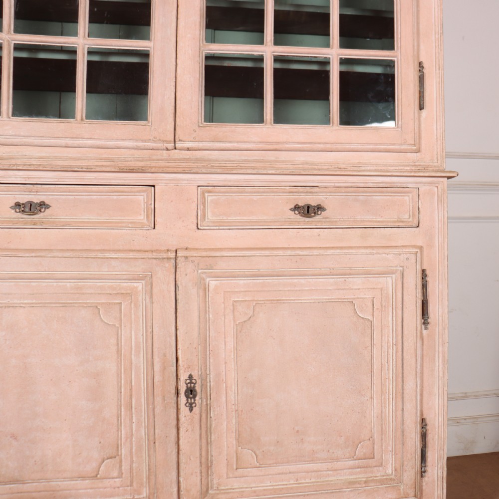 A nineteenth-century French painted glazed dresser featuring arched multi-pane glass doors with a green interior above two drawers and cupboard doors. View V