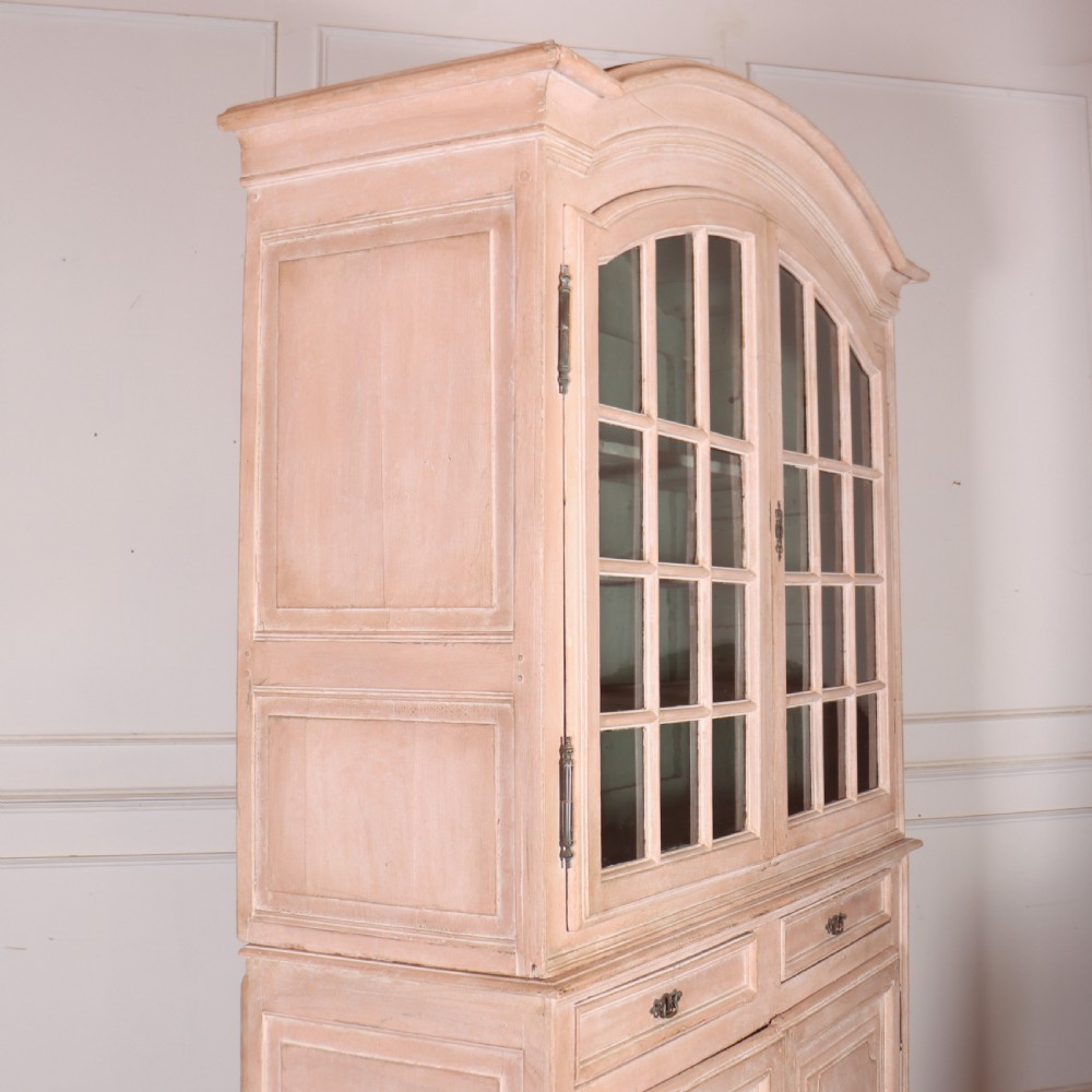 A nineteenth-century French painted glazed dresser featuring arched multi-pane glass doors with a green interior above two drawers and cupboard doors. View X
