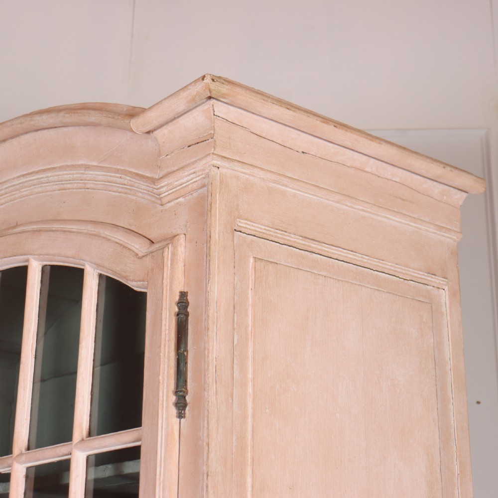 A nineteenth-century French painted glazed dresser featuring arched multi-pane glass doors with a green interior above two drawers and cupboard doors. View XII