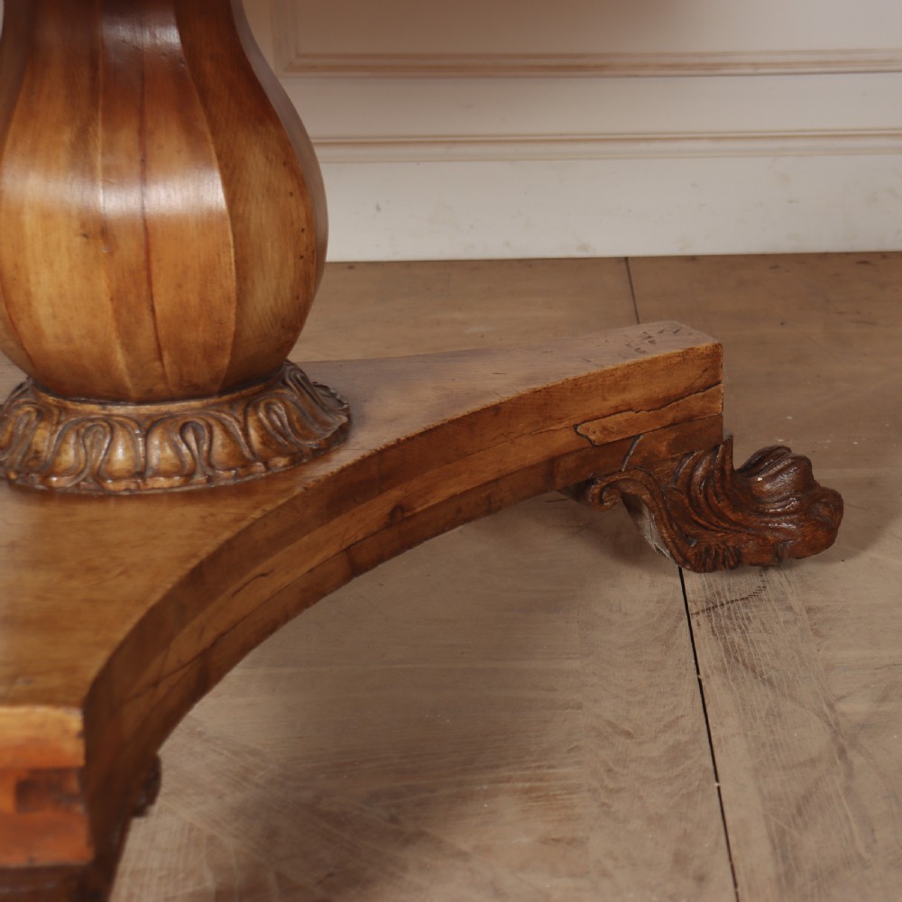 A large 19th-century circular wood supper table featuring a bulbous turned pedestal column and carved paw feet on a triform base. View IV