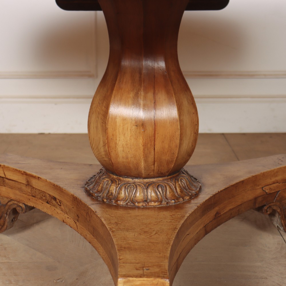 A large 19th-century circular wood supper table featuring a bulbous turned pedestal column and carved paw feet on a triform base. View VI
