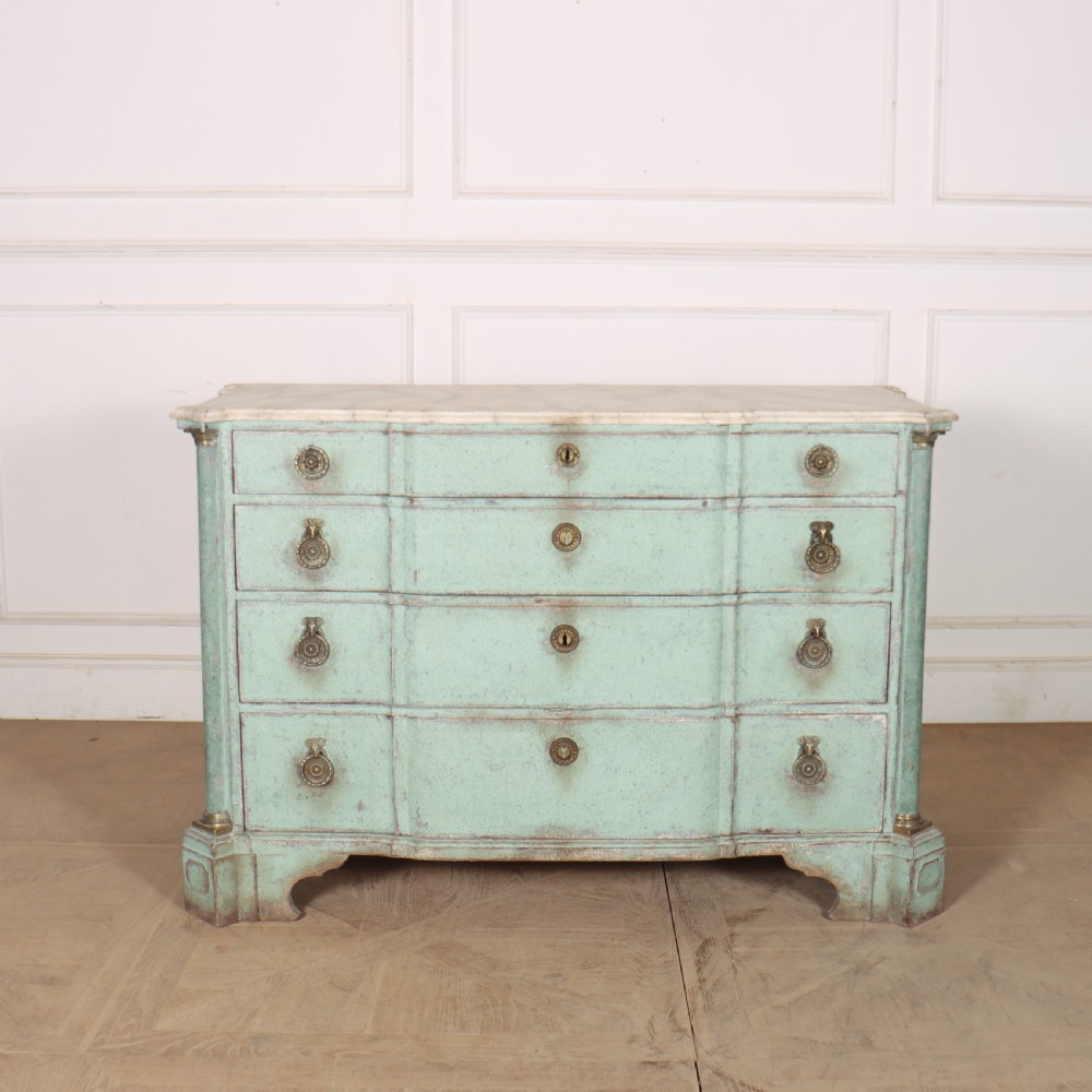 An 18th-century Dutch breakfront commode featuring a pale green painted finish, four drawers with brass ring handles, and a light marble top.