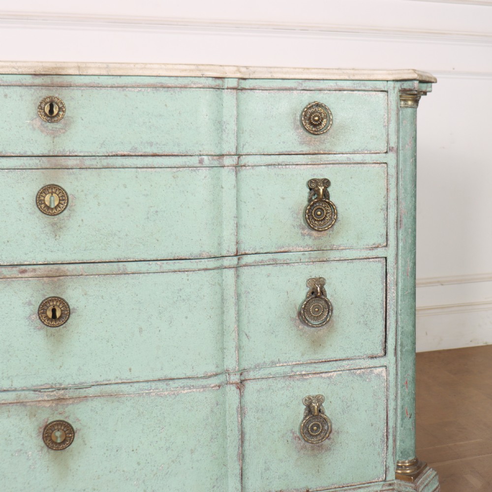 An 18th-century Dutch breakfront commode featuring a pale green painted finish, four drawers with brass ring handles, and a light marble top. View VI