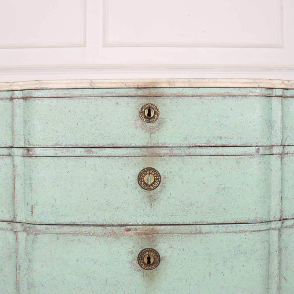 An 18th-century Dutch breakfront commode featuring a pale green painted finish, four drawers with brass ring handles, and a light marble top. View VII