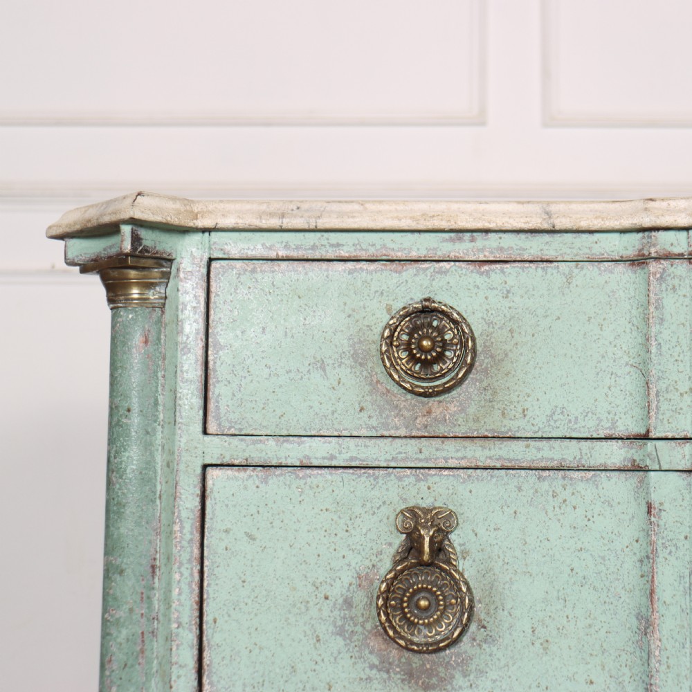 An 18th-century Dutch breakfront commode featuring a pale green painted finish, four drawers with brass ring handles, and a light marble top. View IX