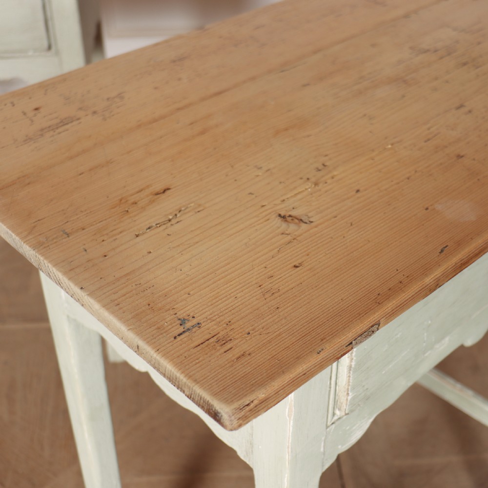 A pair of 19th-century English side tables featuring natural pine tops, single frieze drawers, and pale green painted bases with square tapered legs. View IV