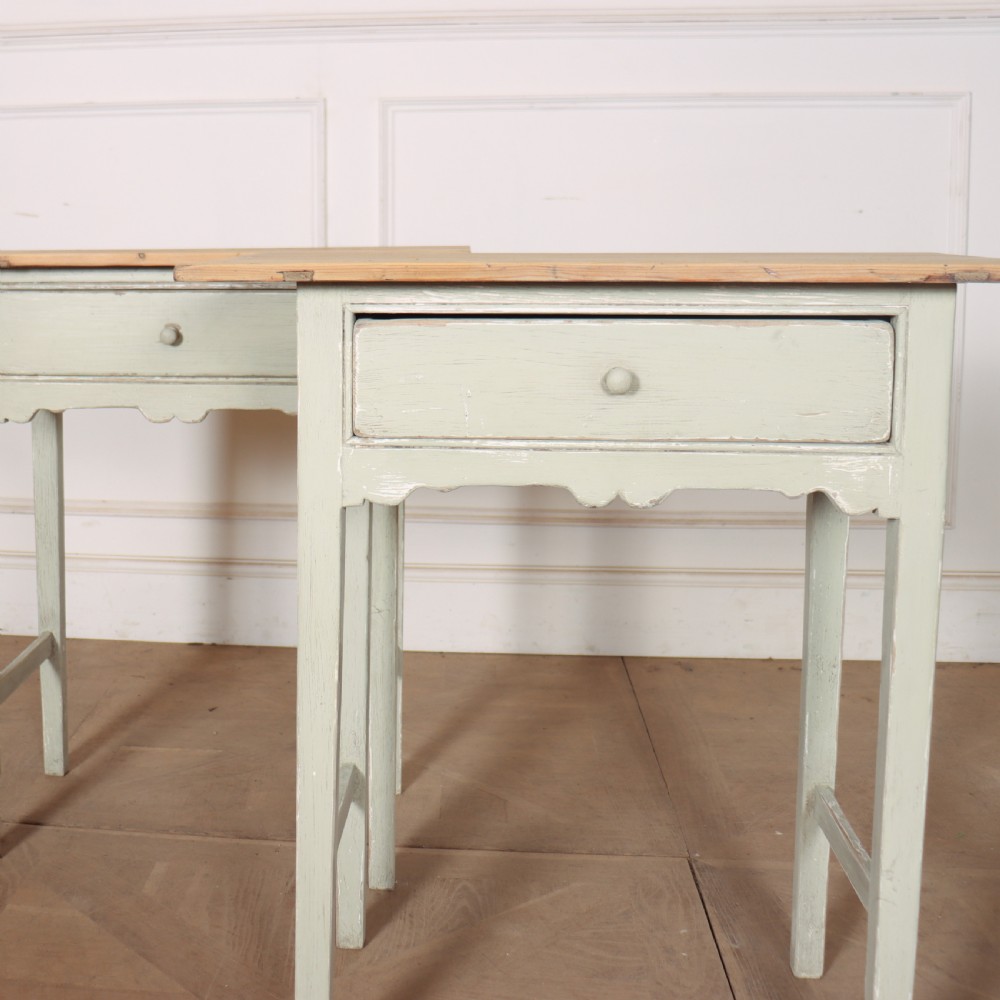 A pair of 19th-century English side tables featuring natural pine tops, single frieze drawers, and pale green painted bases with square tapered legs. View V