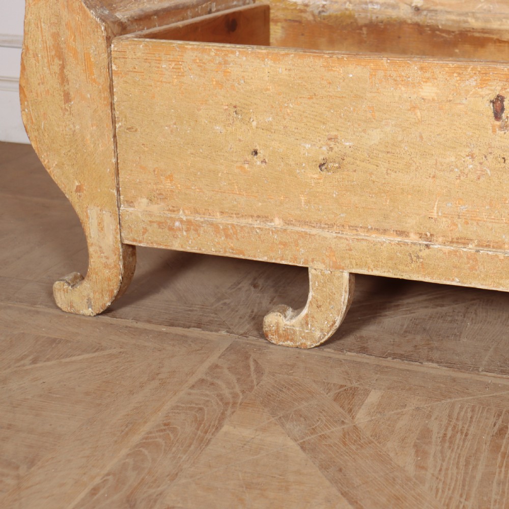A Swedish wooden storage bench featuring a contoured backrest, rolled armrests, and an open seat box with distressed yellow paint finish. View VIII