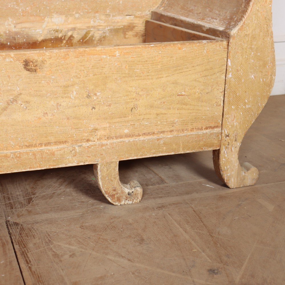 A Swedish wooden storage bench featuring a contoured backrest, rolled armrests, and an open seat box with distressed yellow paint finish. View IX