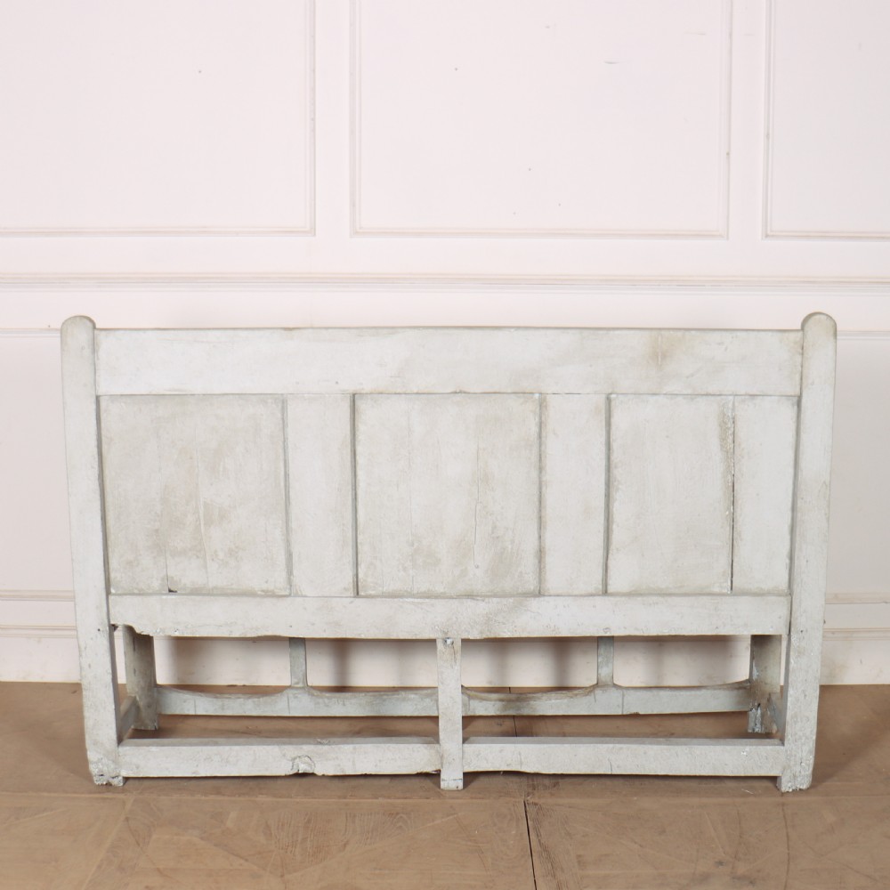 An 18th-century painted wooden tavern bench featuring a high back with three recessed panels, curved armrests, and lower stretchers. View X