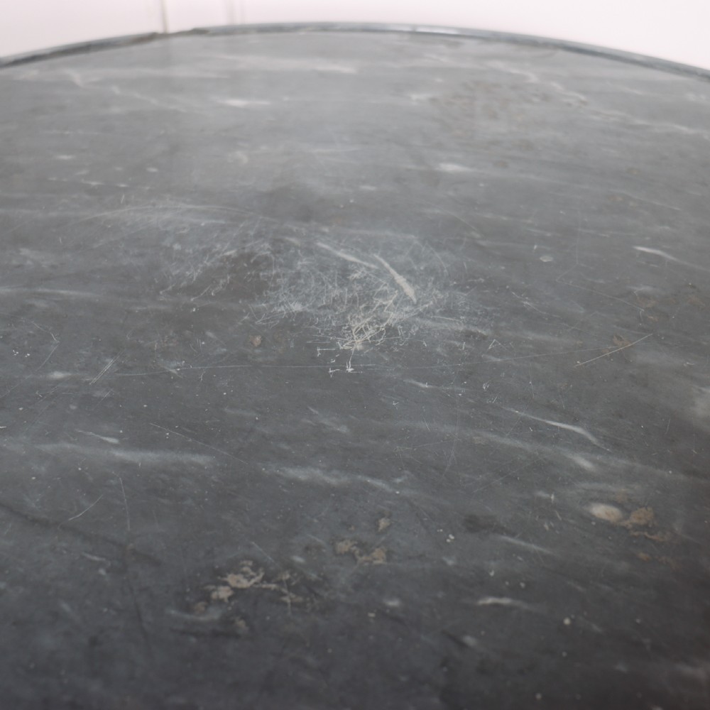 A large circular French gueridon table featuring a dark grey marble top set upon a dark mahogany pedestal base with a triform platform and carved paw feet. View VII