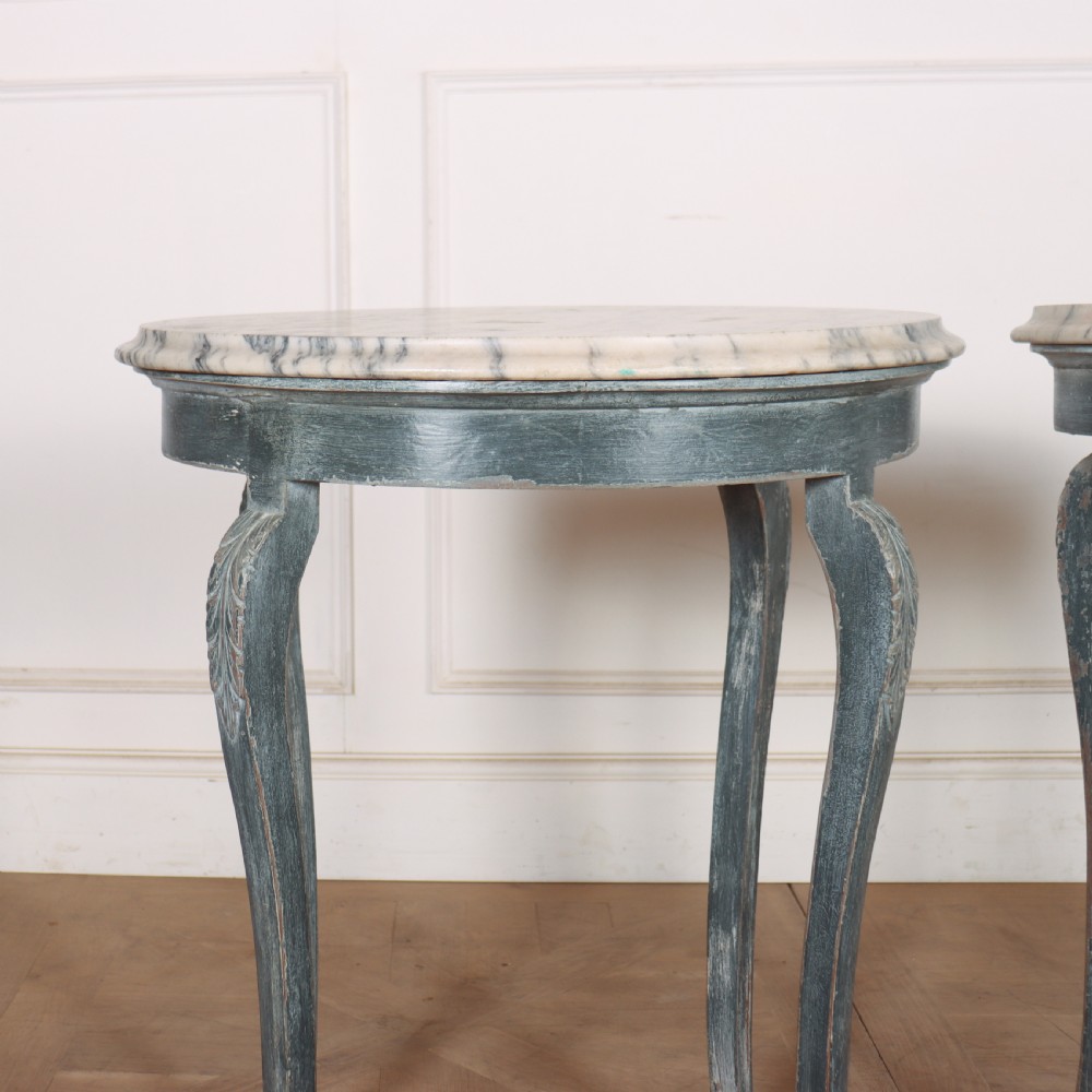 A pair of slim French painted wooden lamp tables featuring cabriole legs and oval marble tops. View V