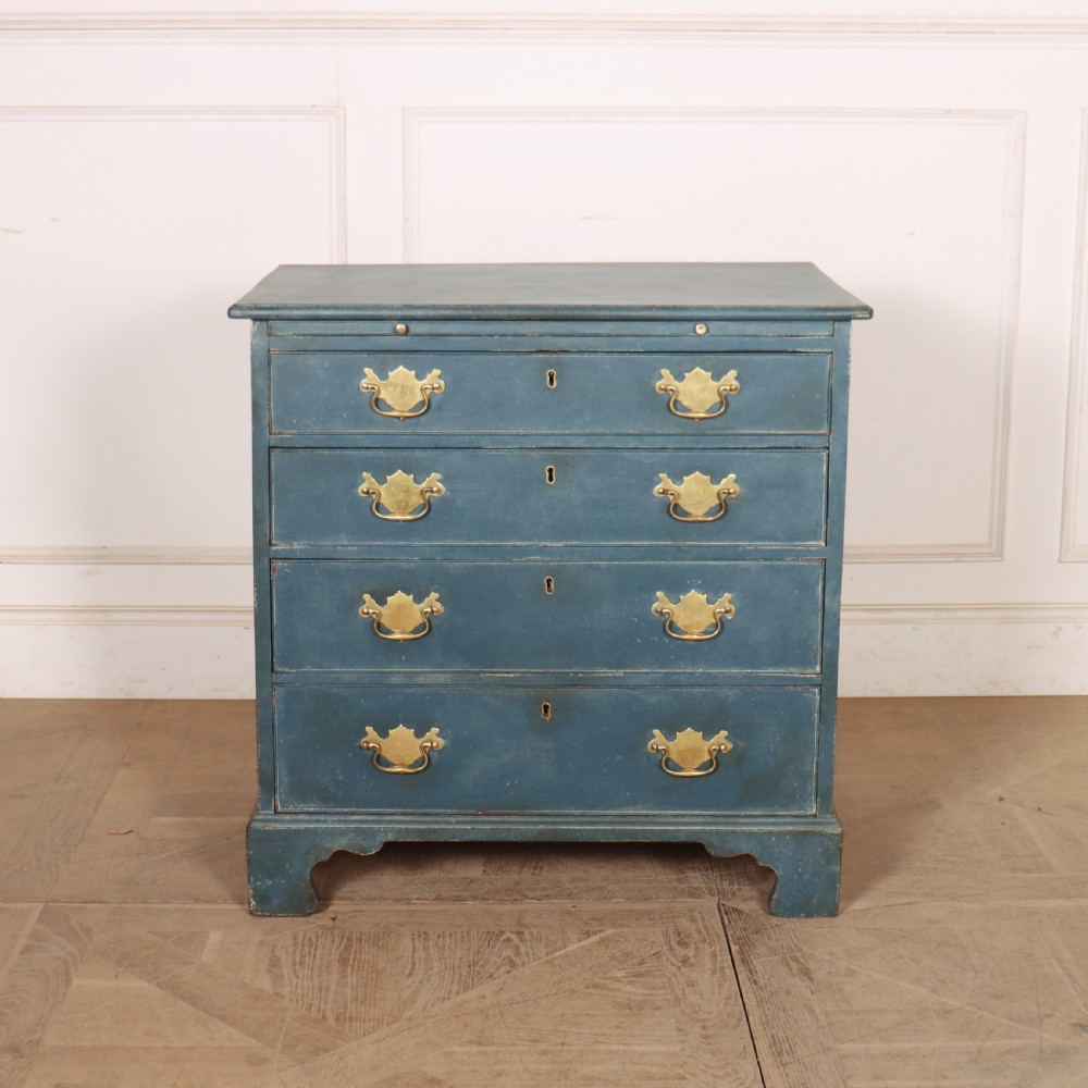 A four-drawer Georgian blue painted chest of drawers featuring brass swan-neck handles and bracket feet.