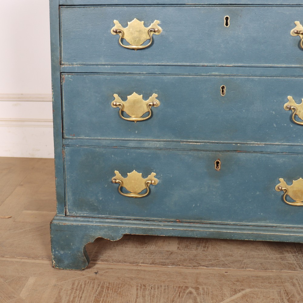A four-drawer Georgian blue painted chest of drawers featuring brass swan-neck handles and bracket feet. View III