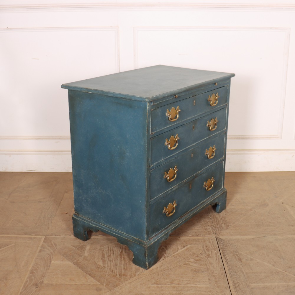 A four-drawer Georgian blue painted chest of drawers featuring brass swan-neck handles and bracket feet. View VII