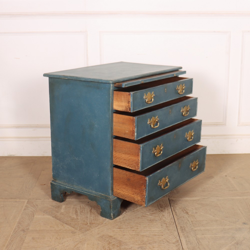 A four-drawer Georgian blue painted chest of drawers featuring brass swan-neck handles and bracket feet. View VIII