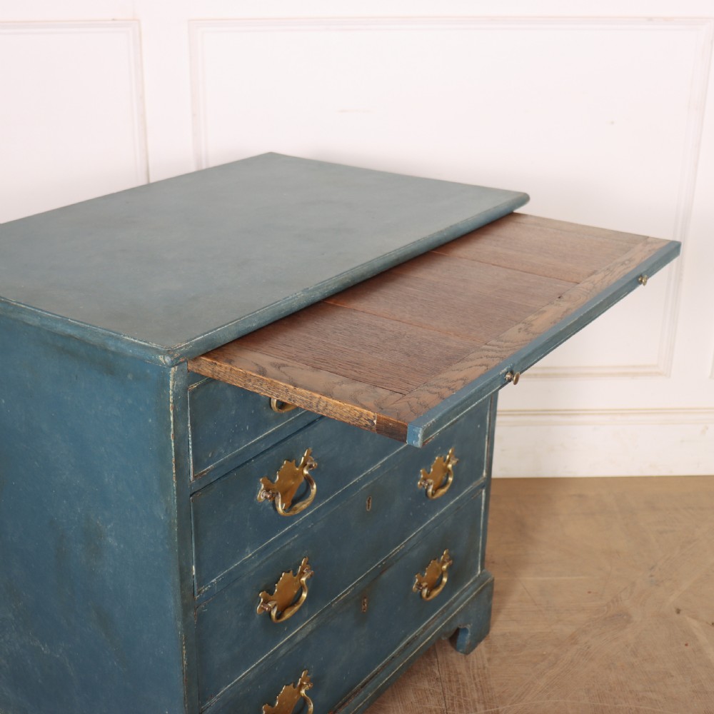 A four-drawer Georgian blue painted chest of drawers featuring brass swan-neck handles and bracket feet. View IX