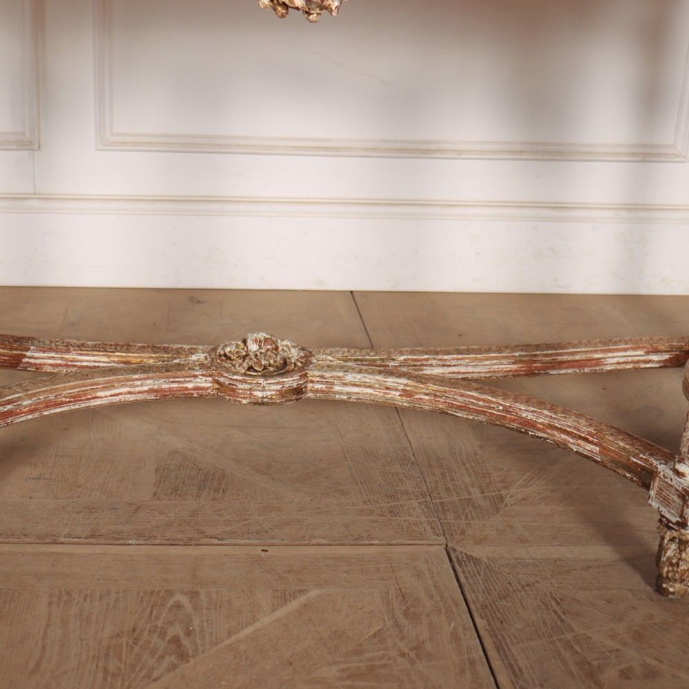 A 19th-century French demi-lune console table featuring a green marble top, ornate carved giltwood frieze with floral swags, and fluted legs. View III