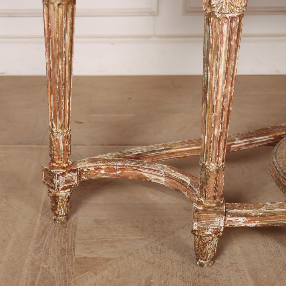 A 19th-century French demi-lune console table featuring a green marble top, ornate carved giltwood frieze with floral swags, and fluted legs. View VIII