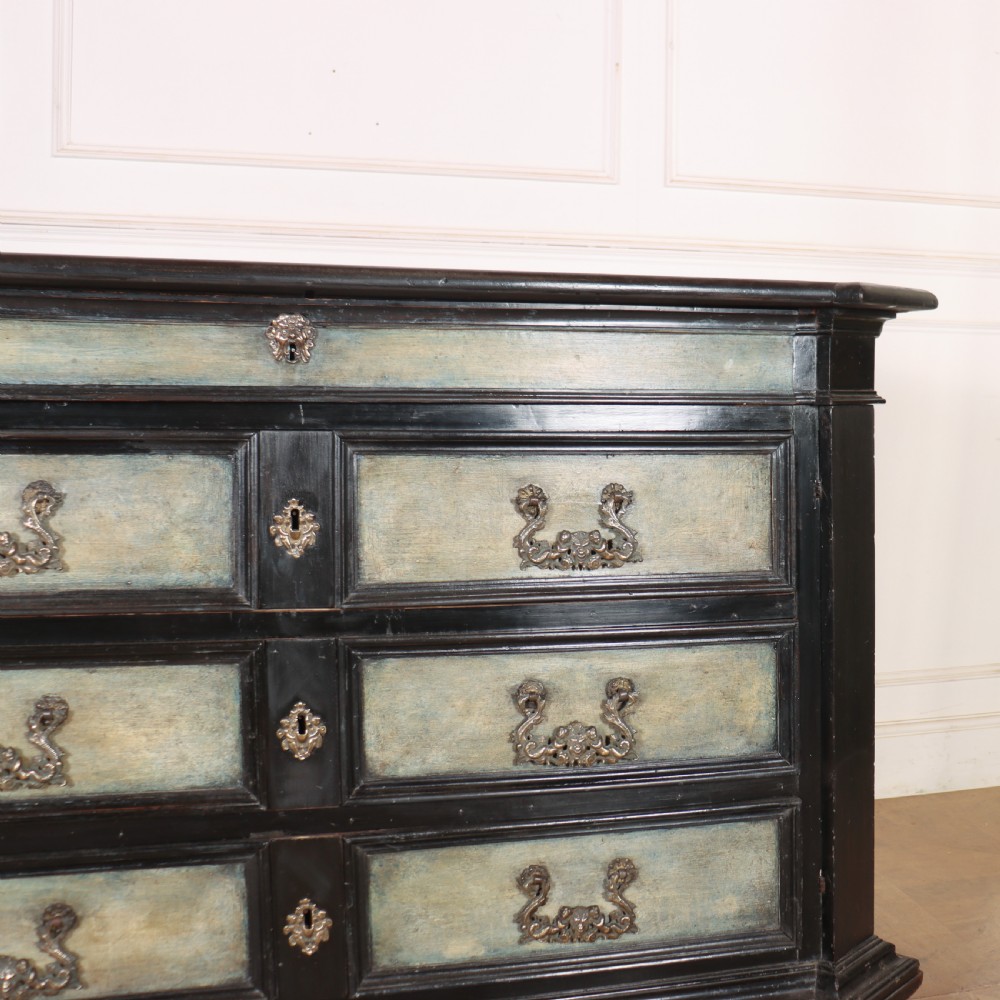 An 18th-century Italian three-drawer commode with a black painted frame, pale blue drawer panels, ornate brass handles, and bun feet. View III