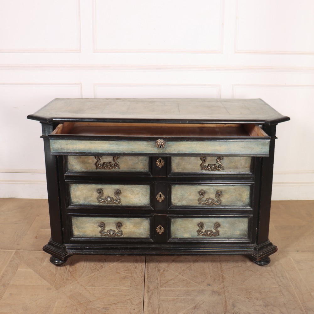 An 18th-century Italian three-drawer commode with a black painted frame, pale blue drawer panels, ornate brass handles, and bun feet. View XIV
