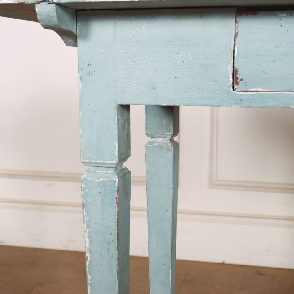 A rectangular light blue painted wooden lamp table featuring square tapered legs and a single drawer with a round brass knob. View V