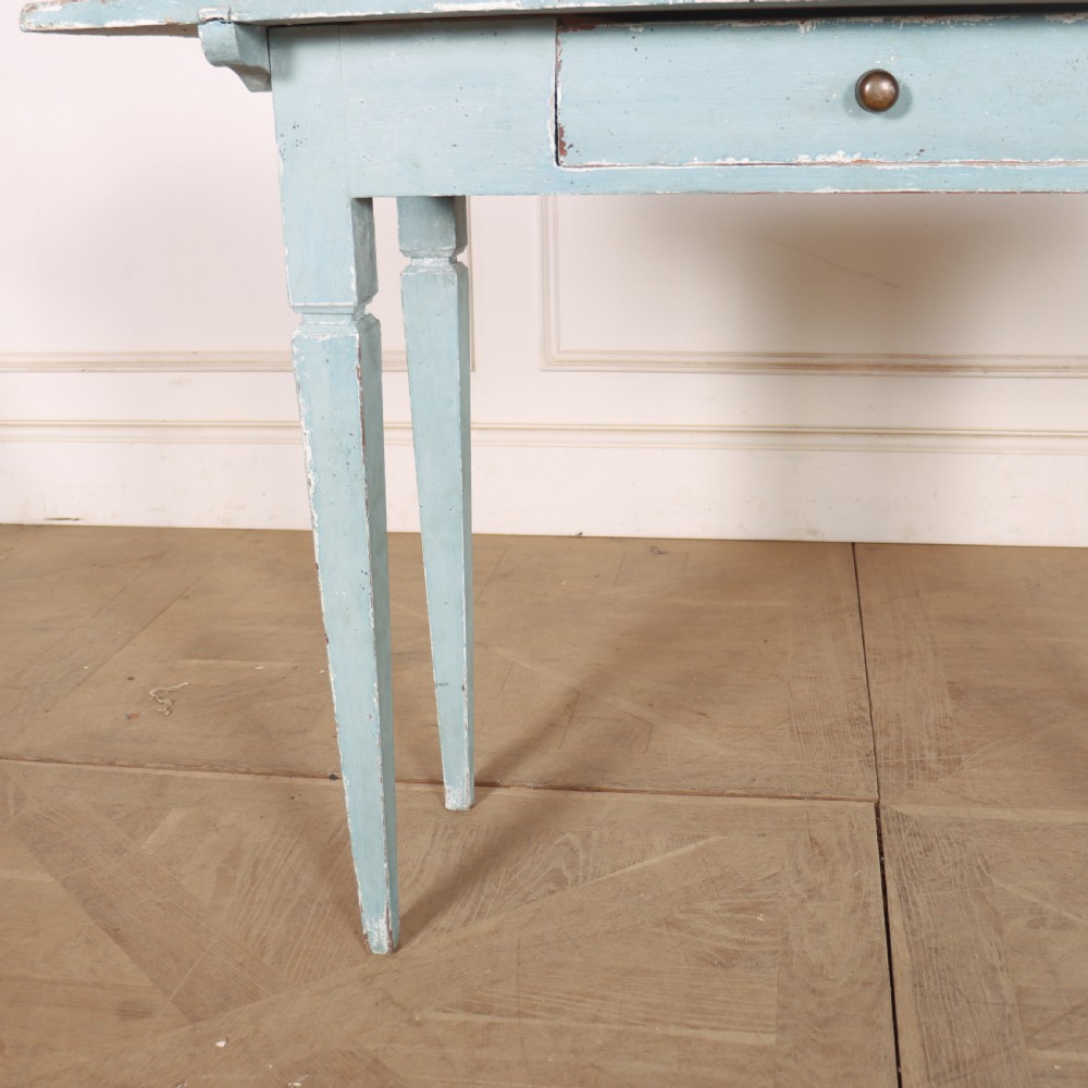 A rectangular light blue painted wooden lamp table featuring square tapered legs and a single drawer with a round brass knob. View VII