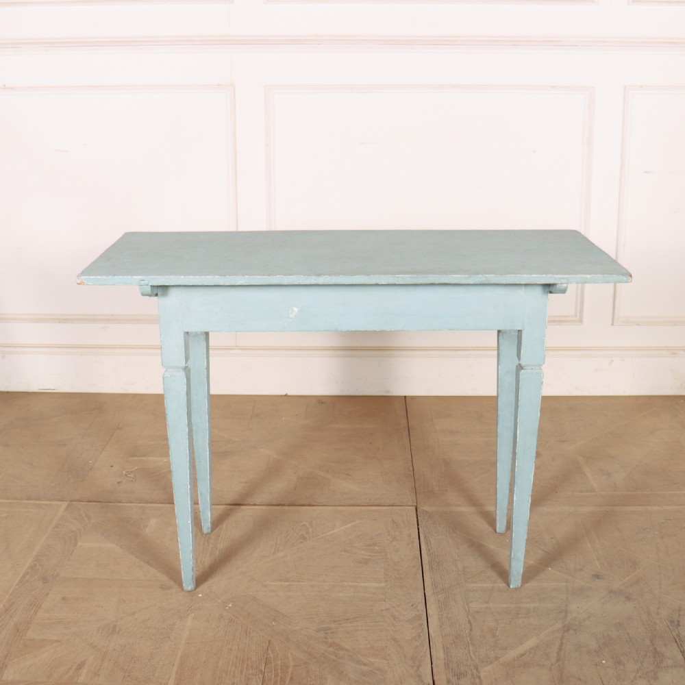 A rectangular light blue painted wooden lamp table featuring square tapered legs and a single drawer with a round brass knob. View IX